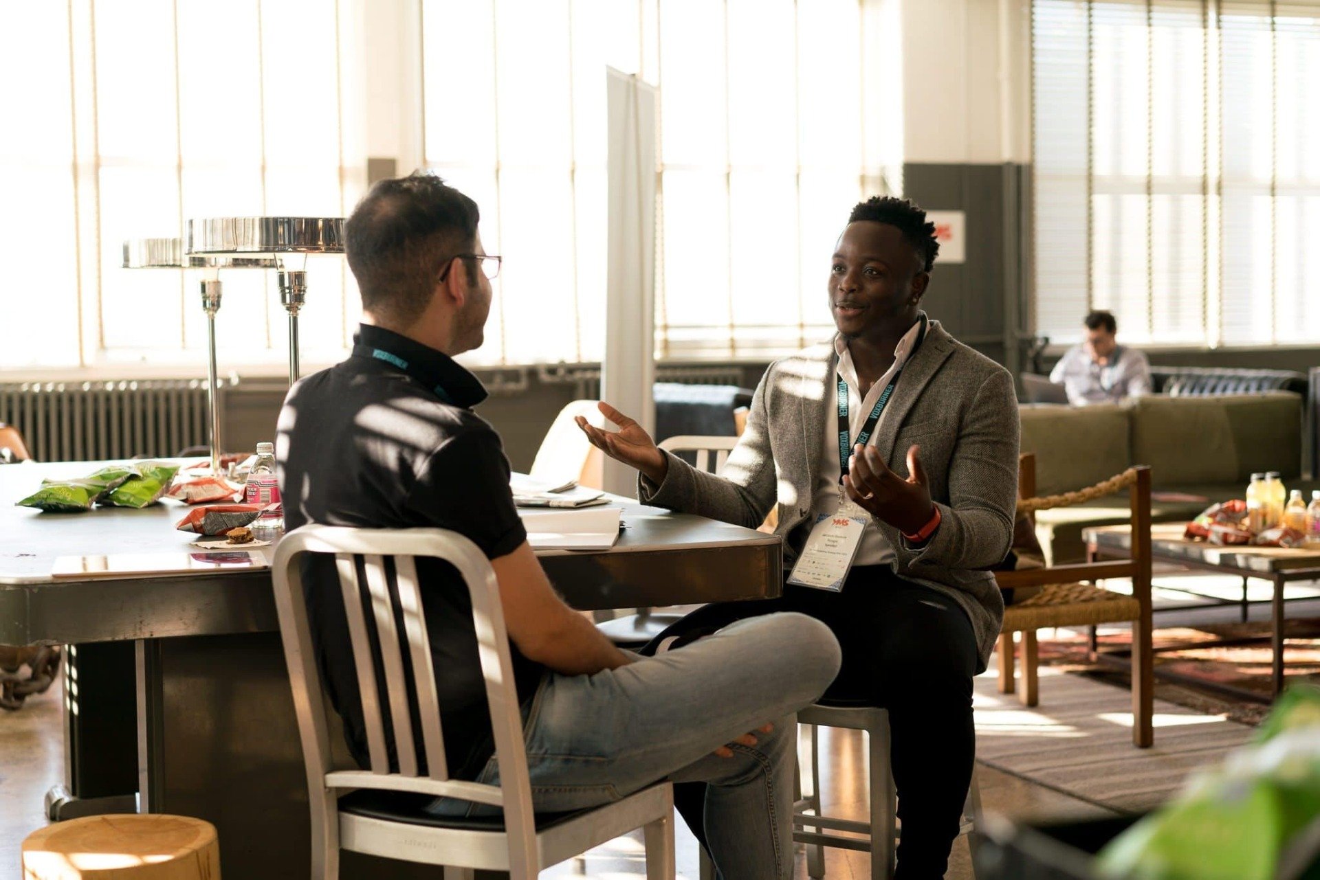 Two men sitting at a table having a conversation