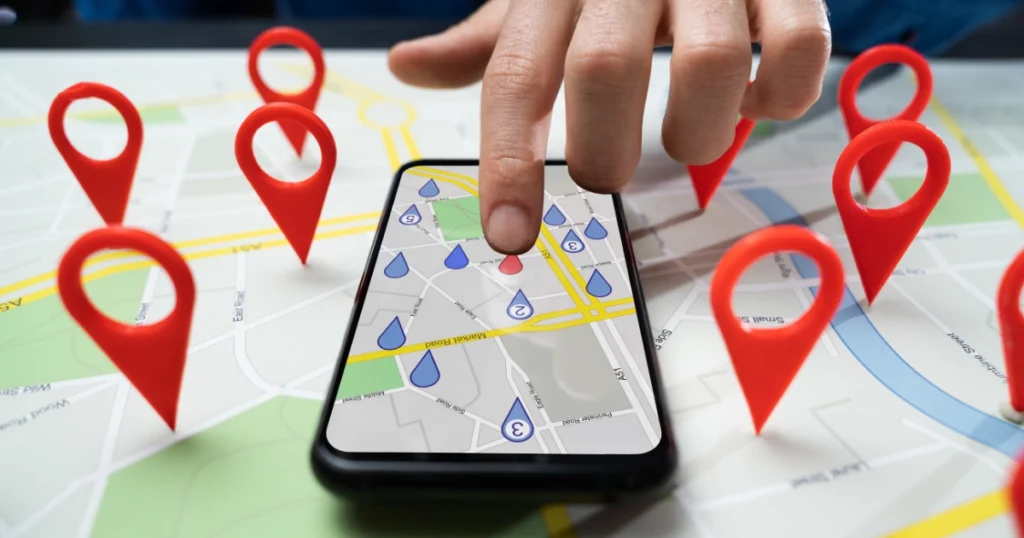 Finger clicking on local SEO on maps app on phone