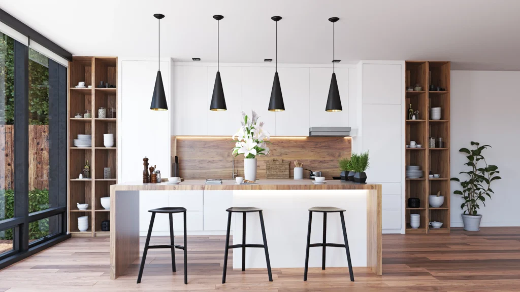Modern kitchen with white and wood finishes, green plants and large black sliding doors to backyard