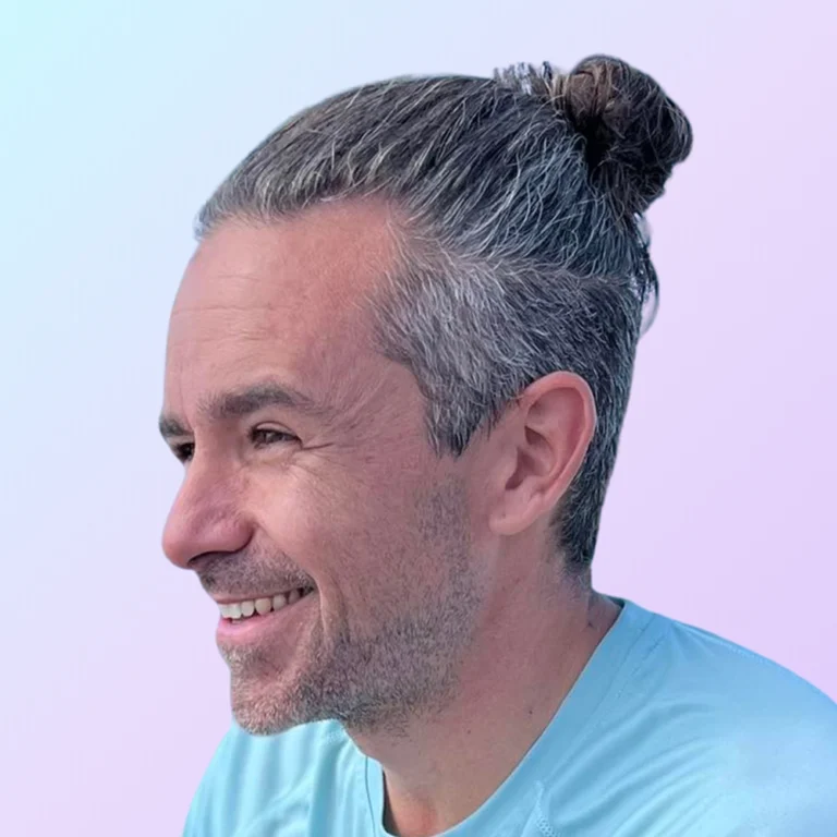 Cam Falzone, web developer at 828 Biz Marketing, smiling and looking to the left while wearing a light blue shirt.