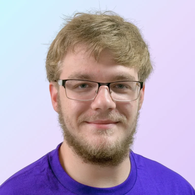 John Komperda, marketing intern at 828 Biz Marketing, smiling and wearing a purple t-shirt